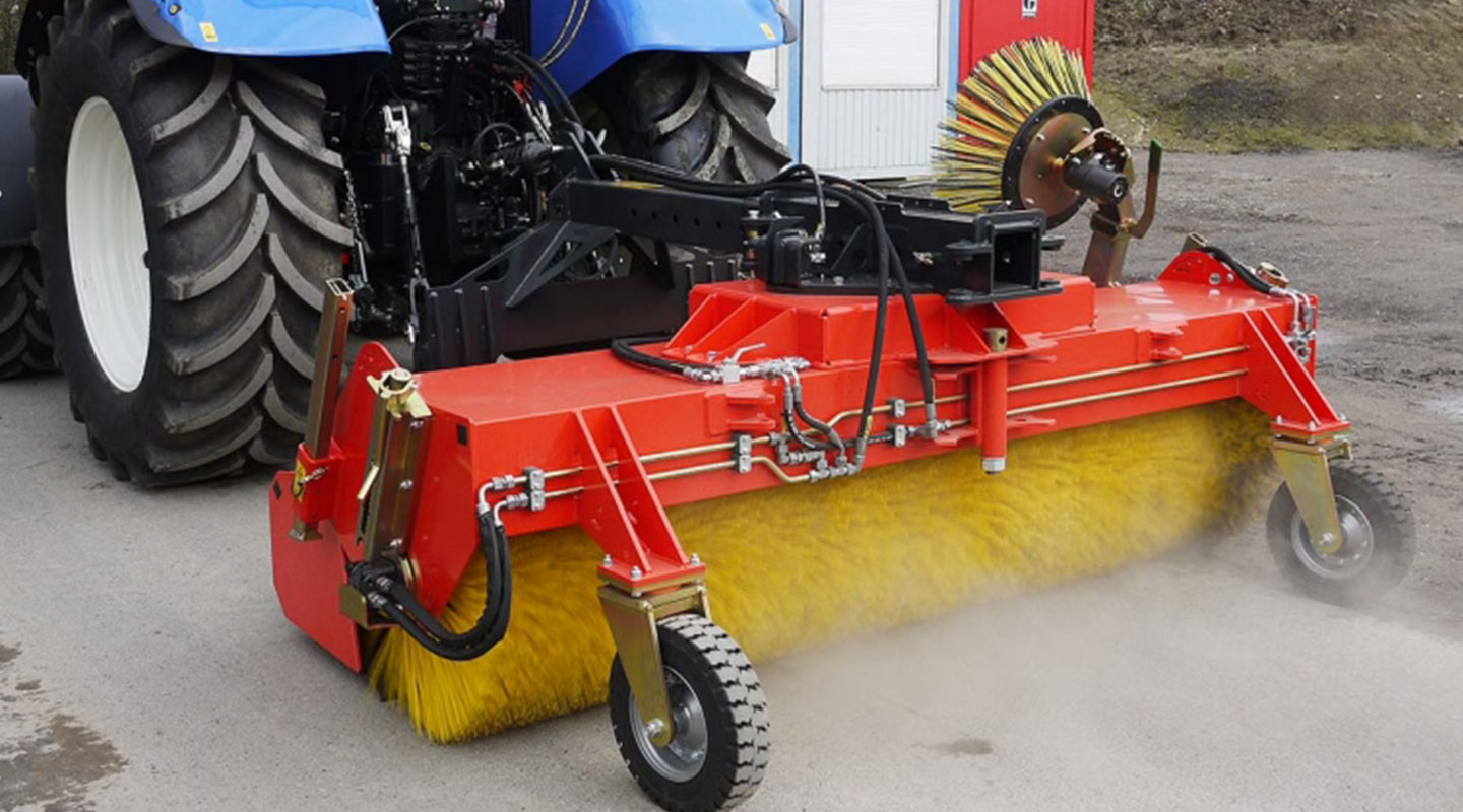 Kehrmaschine K750 von ADLER Arbeitsmaschinen im Heckanbau am Traktor im Einsatz in der Landwirtschaft.